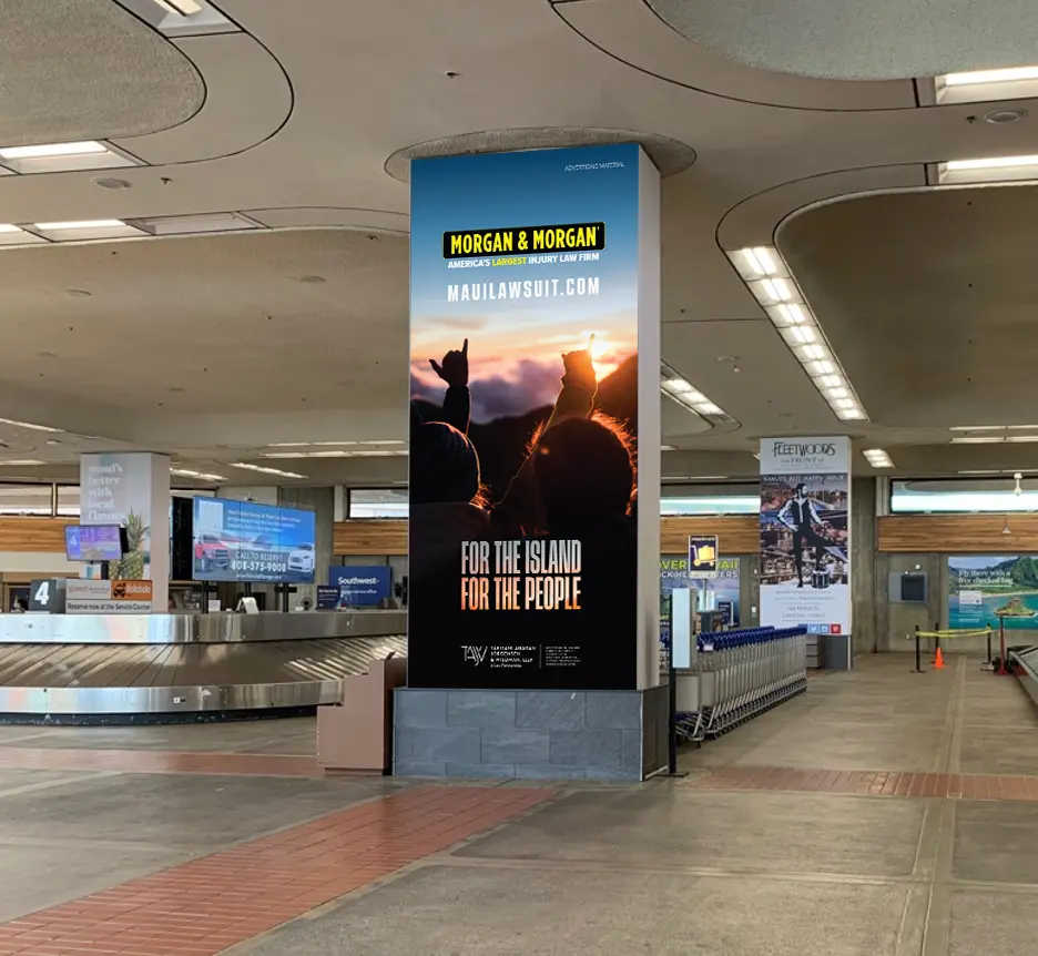 Baggage area of Maui Airport with Morgan & Morgan ads