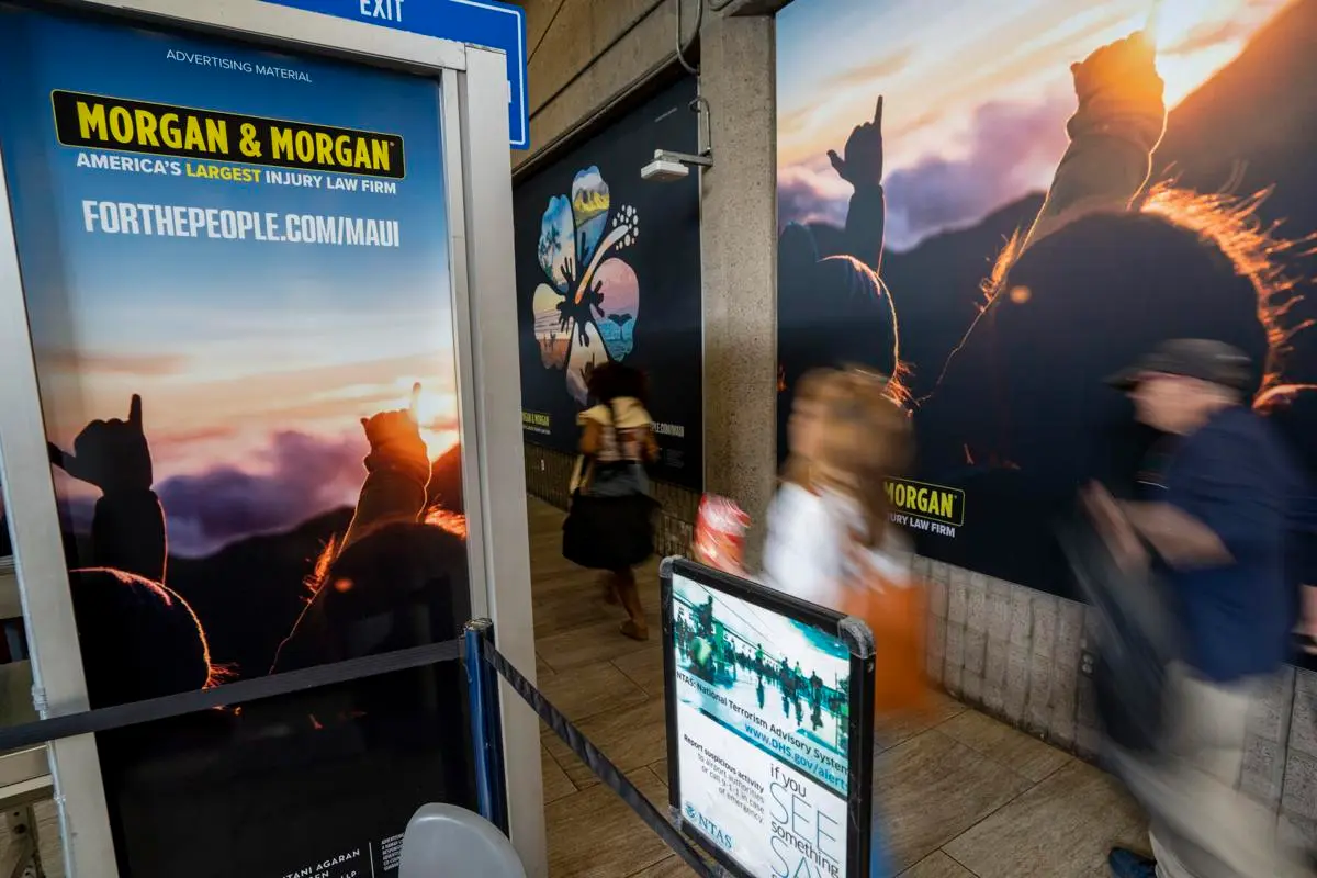 Wall and hallway in Maui Airport with Morgan & Morgan ads