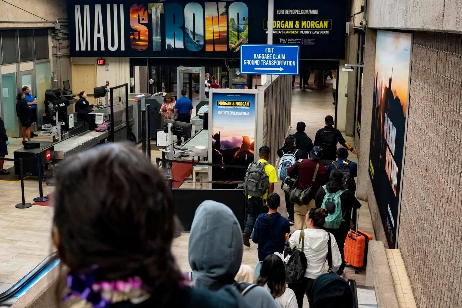 Main Concourse of Maui Airport covered in Morgan & Morgan ads